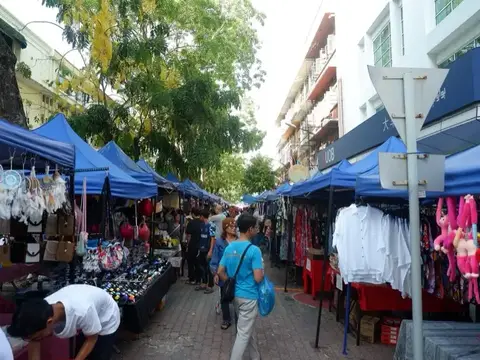 Stalls under blue canopies along Gaya Street on a Sunday morning